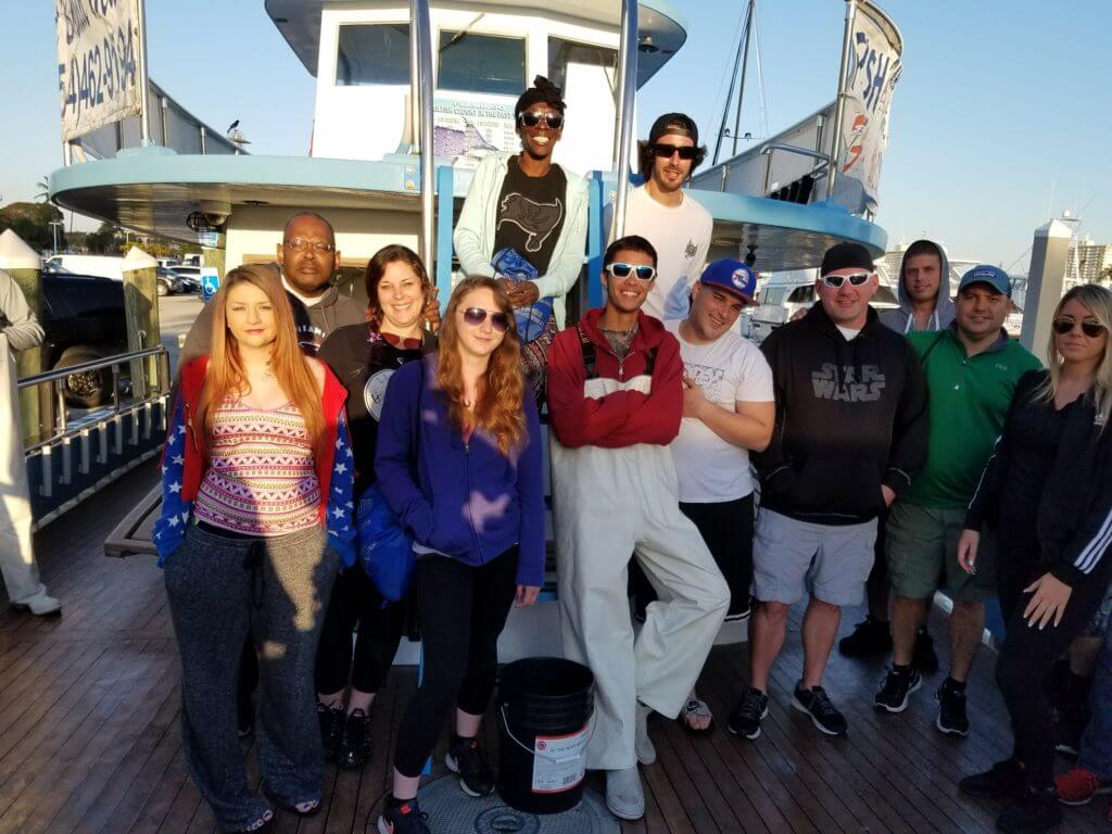 Clients holding their catch on a deep sea fishing trip